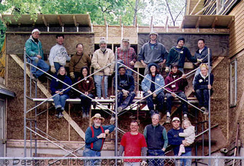 the whole group poses on the scaffolding